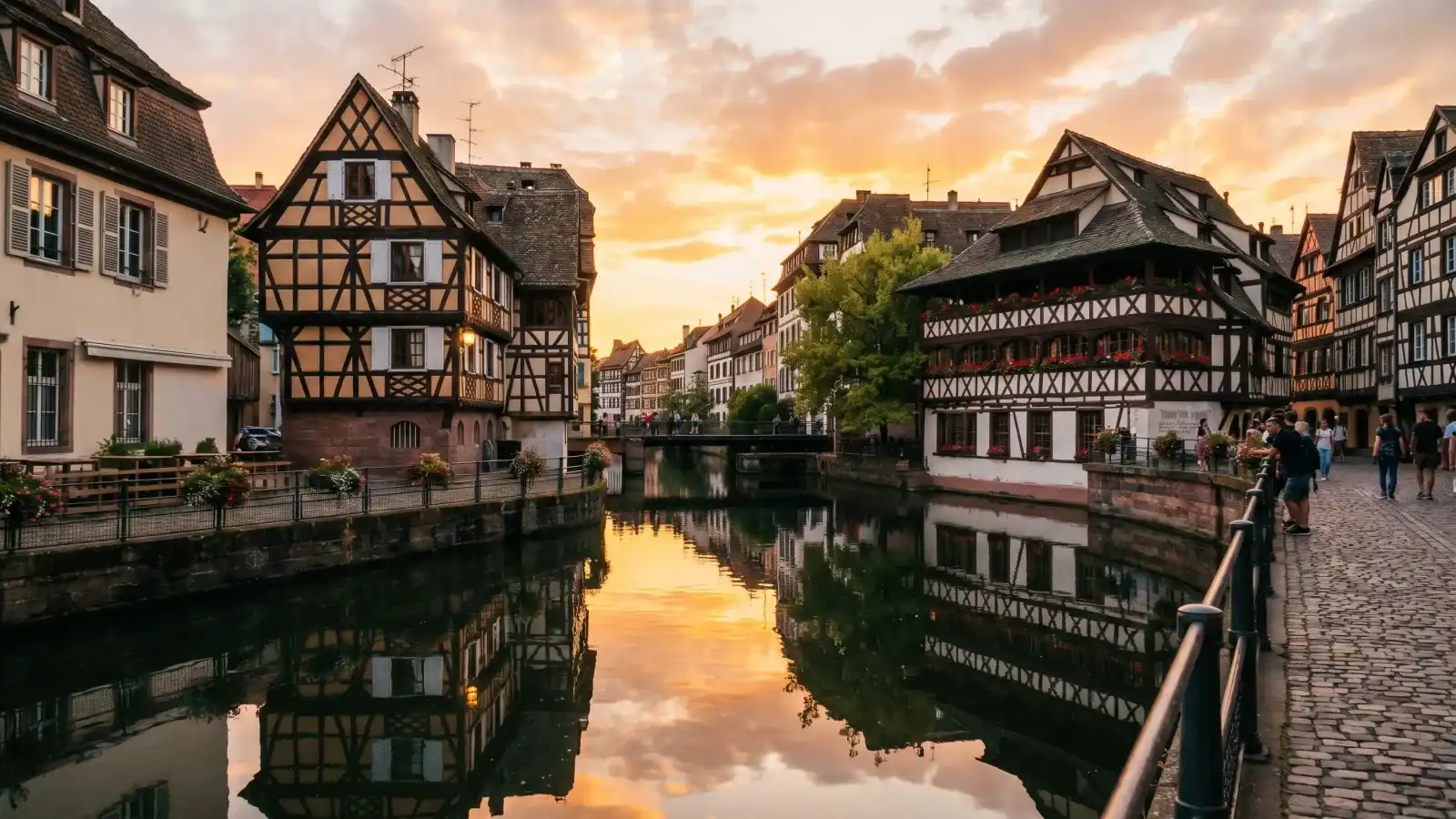 Half-timbered houses reflected in a Strasbourg canal at sunset