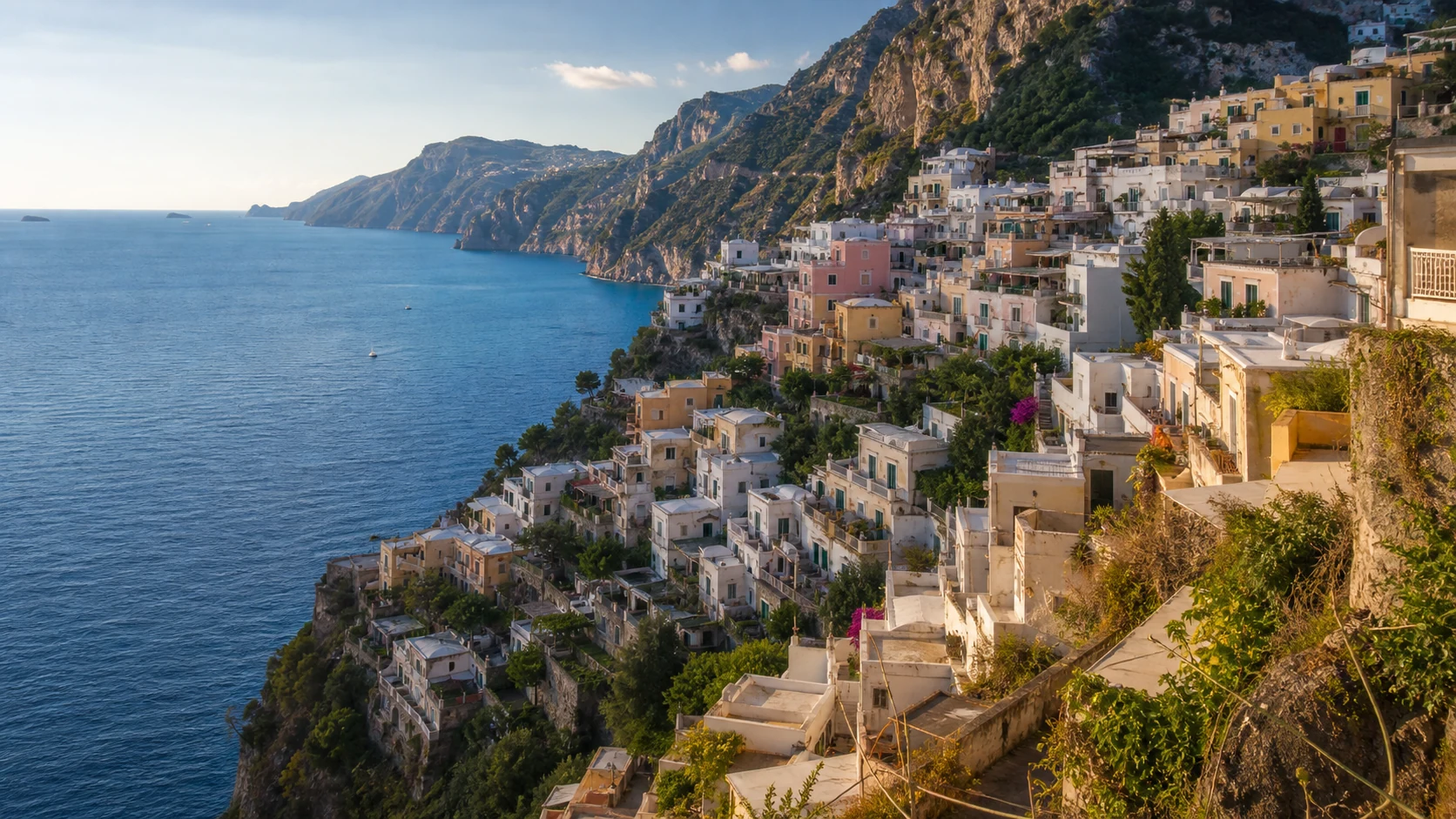 Praiano village cascading down Amalfi Coast cliffs above the Tyrrhenian Sea at golden hour