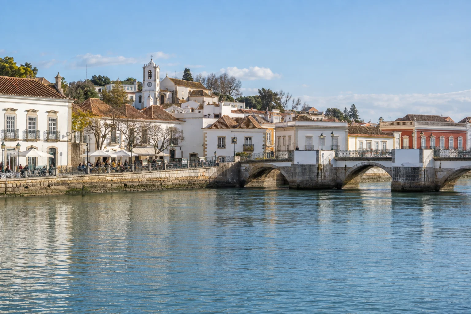 Generated illustration of Tavira's tiled waterfront and arched bridge reflected in the Gilão river