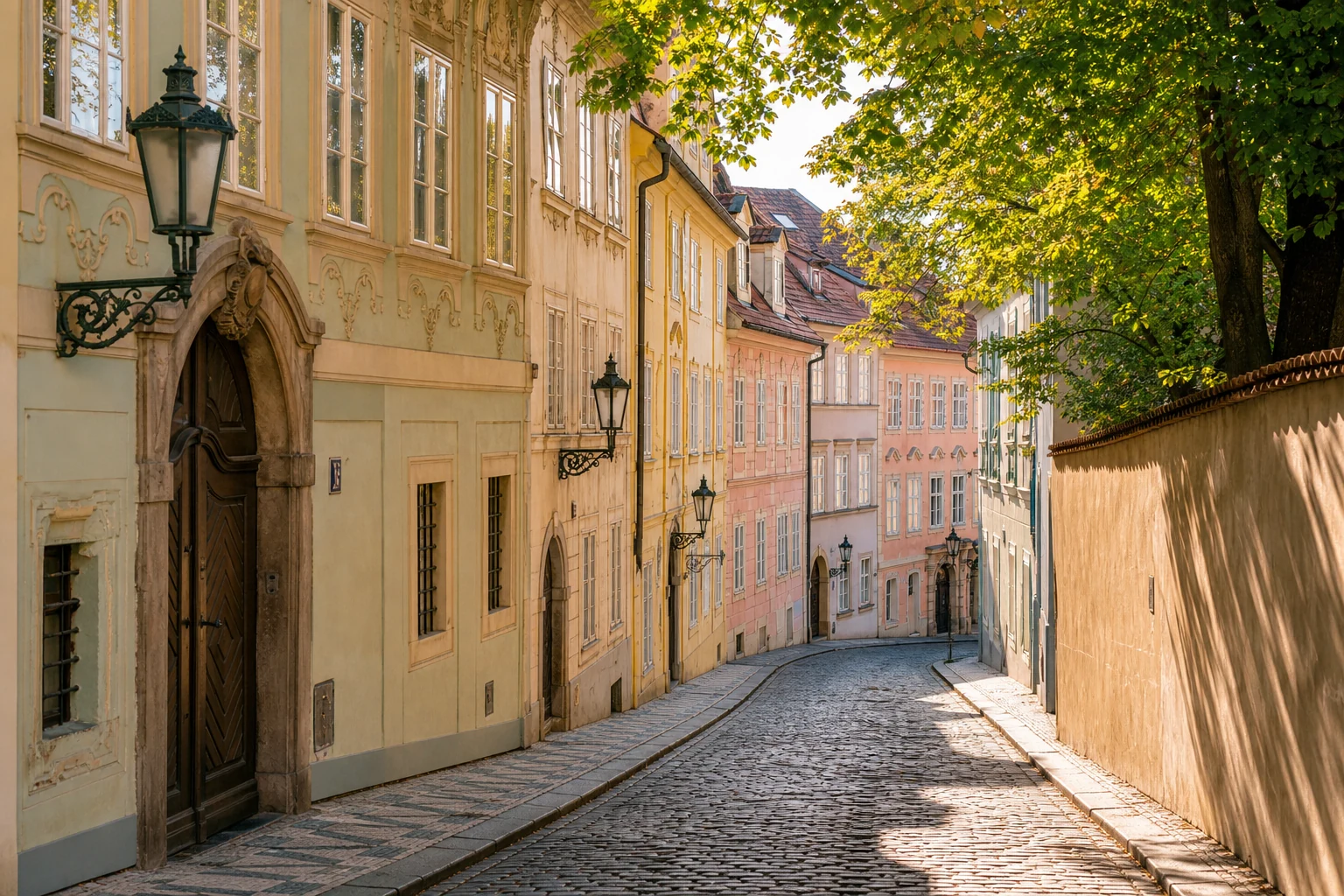 A cobblestone street in Mala Strana, Prague, with Baroque buildings and lanterns