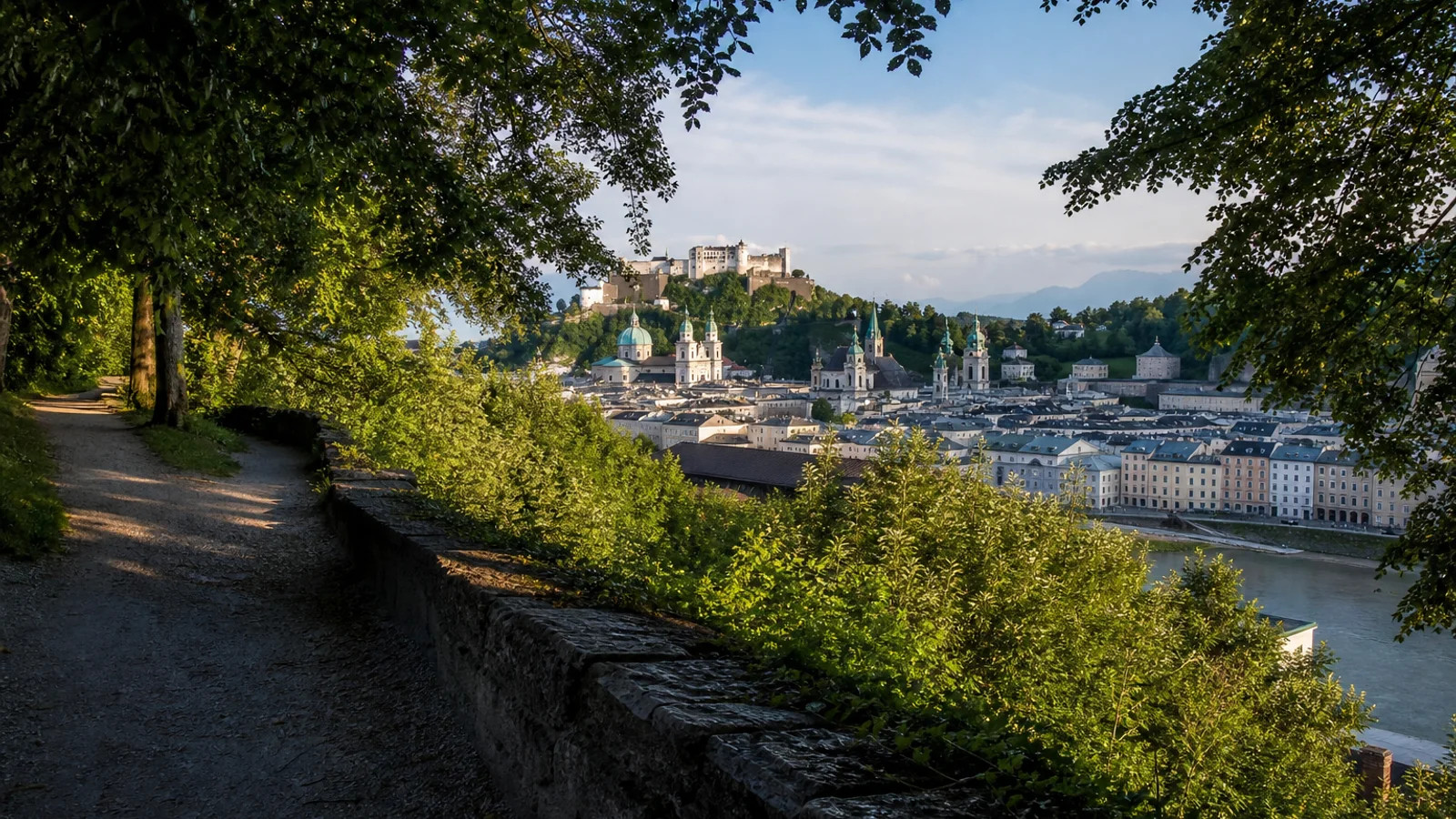 Wooded Mönchsberg path overlooking Salzburg Old Town and Hohensalzburg Fortress